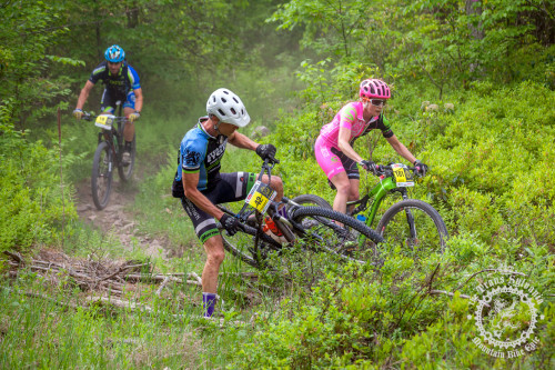 Vicki Barclay (Stan’s NoTubes Elite Women’s Team) passes Russel Henderson (Crosstown Velo) on an enduro segment at the NoTubes Trans-Sylvania Epic. Photo by: Trans-Sylvania Epic Media Team