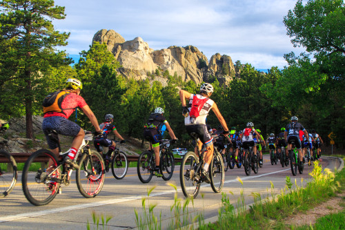 Lee Simril reaches into his back pocket in the shadows of Mount Rushmore - Photo by Jennifer Bush