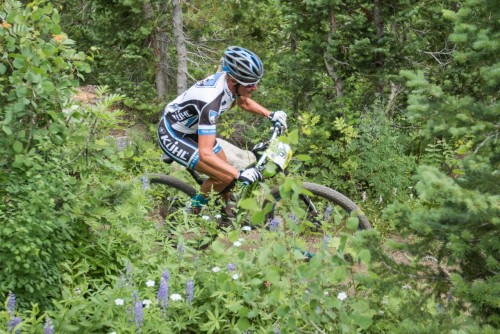 Joey Lythgoe flows through the wild flowers at Snowbird - Photo by Angie Harker