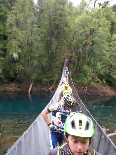 Riders crossing the first of many many suspension bridges at TransAndes. Riders were stuck on the bridge as a ramp at the far end made exiting the bridge very slow. We were later told the bridge had a maximum capacity of 5 people. Photo by: Shannon Boffeli