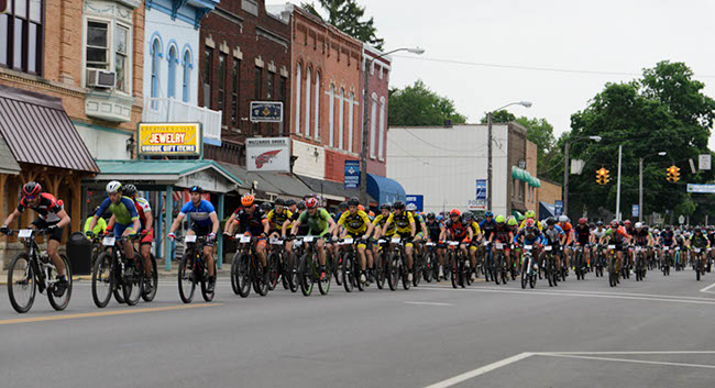 Hundreds of racers charge off the start line and through Loudonville, Ohio, at the start of the Mohican 100. Photo by: Butch Phillips Photography