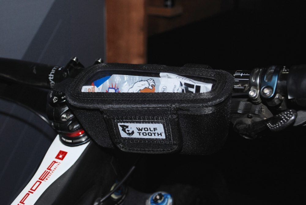 Wolf Tooth's bar-mounted container is perfect for food. The magnetic velcro closure means it shuts itself after removing your goodies. 